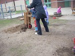 playing in the yard with wooden wheelbarrow