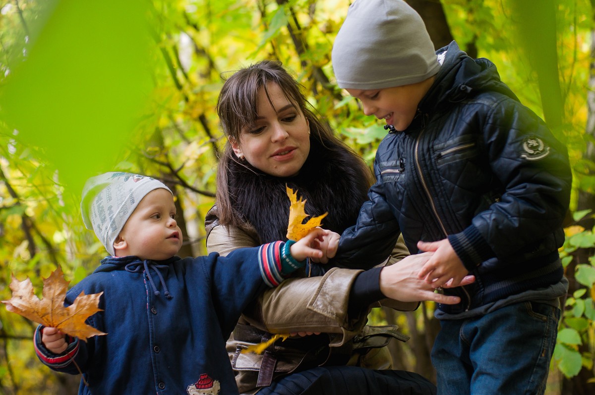 staff caretaker and children in fall